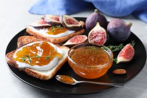 Homemade fig jam served on toasted sourdough with fresh figs and thyme